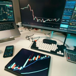 work desk with charts on screen and on a tablets showing sharp drops and increases representing higher AOV and lower deal sizes